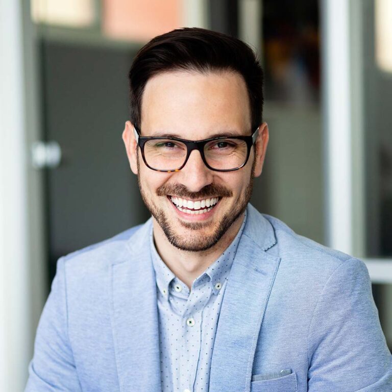 Portrait of handsome successful businessman holding tablet